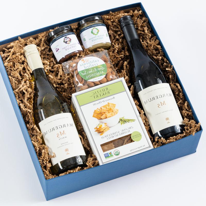 red and white wine in a gift box with crackers, california roasted almonds and tapenade.